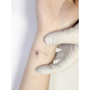 delicate dandelion tattoo